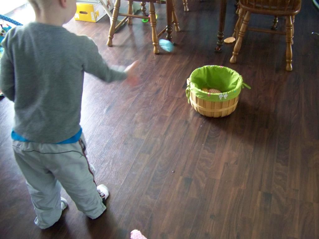 my son tossing the eggs into the basket
