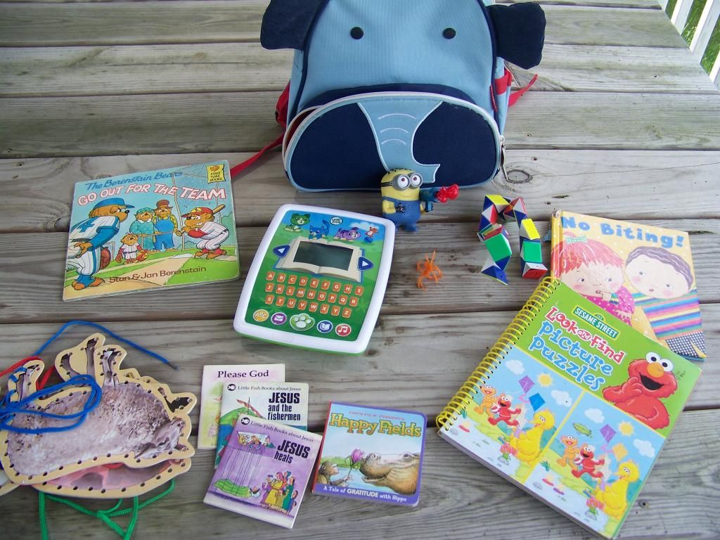 the books and toys in the elephant backpack