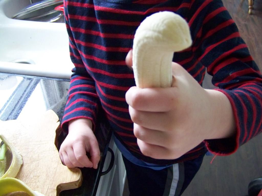 my son holding a banana